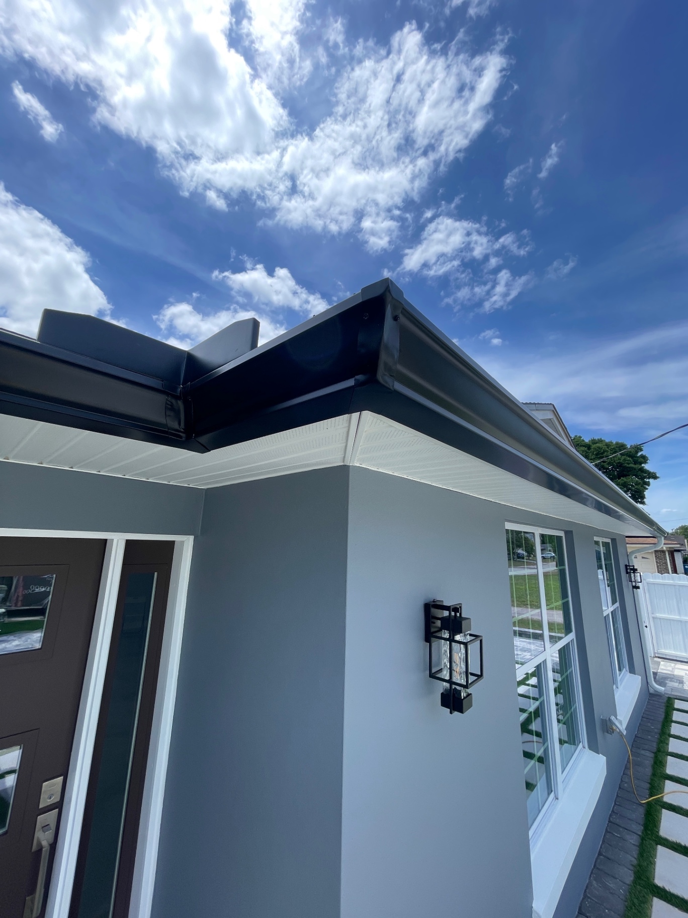 Custom downspout routing · patio side