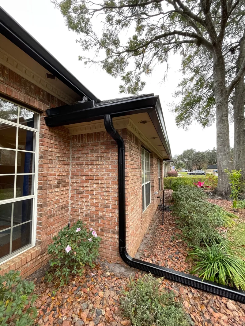 Dark seamless gutters installed on a Northeast Florida home